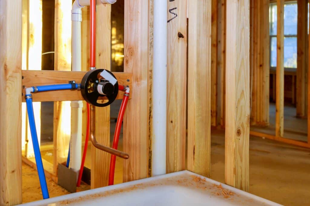 Bathroom remodel under plumbing work connecting installation shower faucet